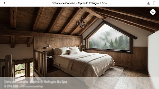 Dormitorio abuhardillado con cama king y ventanal triangular hacia la montaña