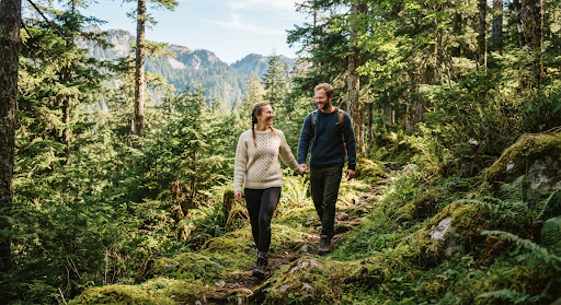 Pareja caminando por sendero de montaña